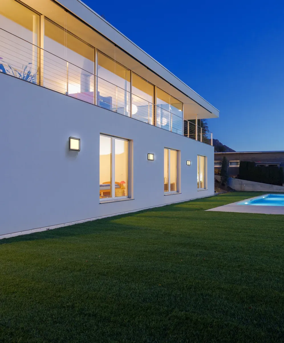 Fachada moderna con iluminación arquitectónica vertical de noche